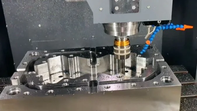 Closeup of VMC machining a heavy metal part