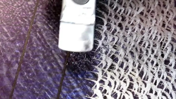 Close up of Worker Scraping the VMC part