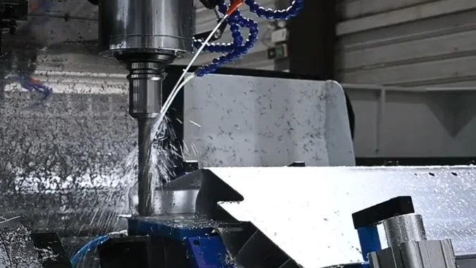 Closeup of Aluminum Profile Machining Center working with coolant