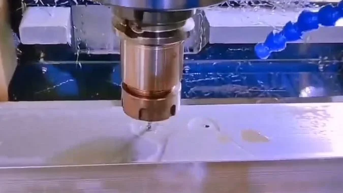Aluminum profile being drilled holes