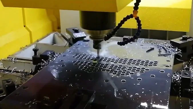 CNC Drilling and Hole Entrance Quality CNC drilling machine machining a metal plate