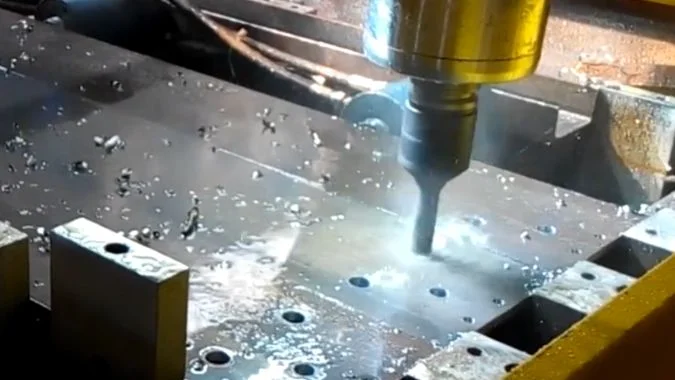 Inspecting a CNC-Drilled Hole CNC machine drilling a clamped metal workpiece