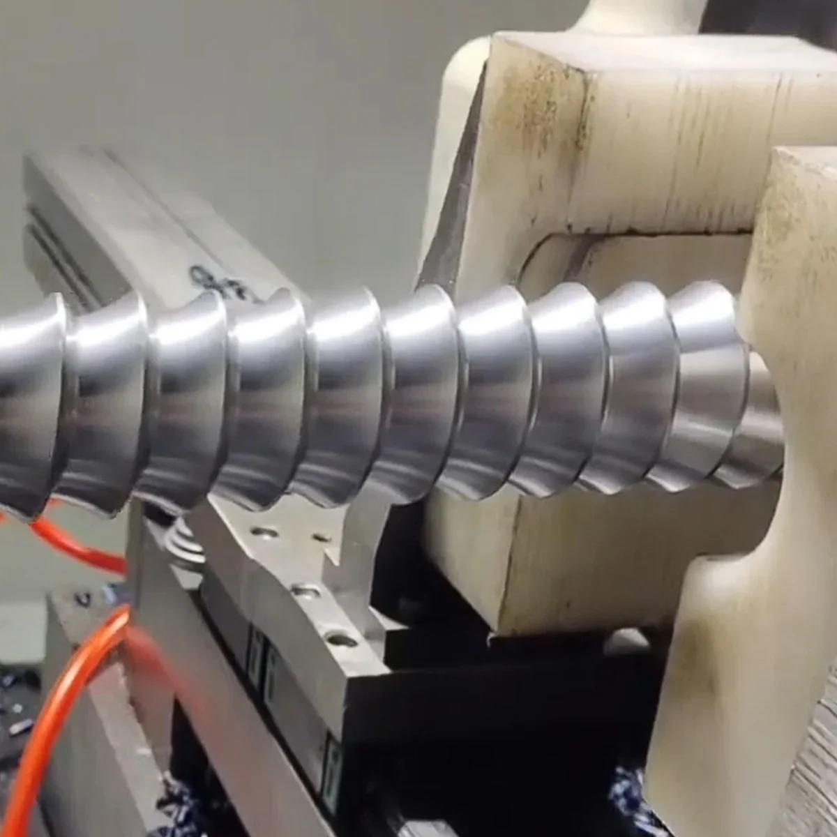 Spiral workpiece beside the thread whirling cutter