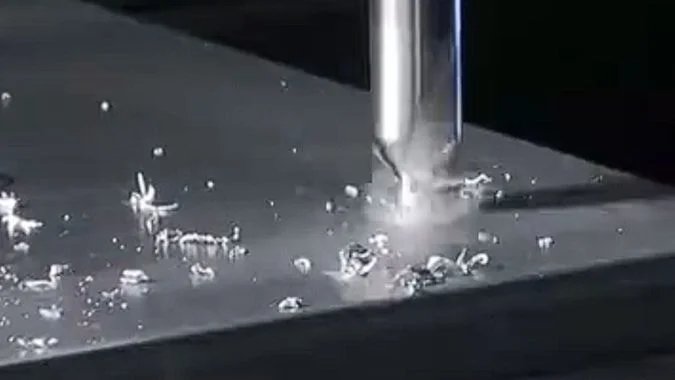 CNC milling machine cutting a metal workpiece