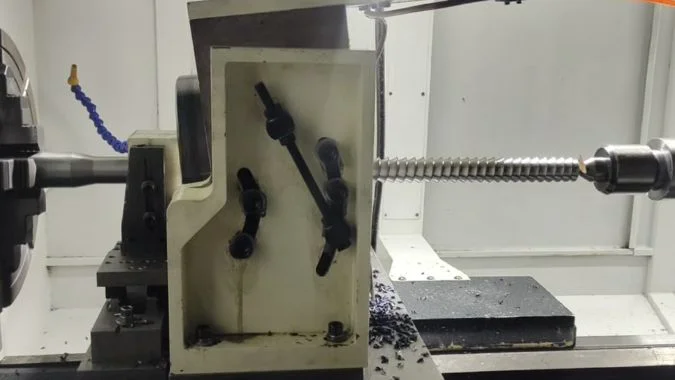 Long Lead Screw During Whirling Long lead screw during thread whirling on a CNC machine