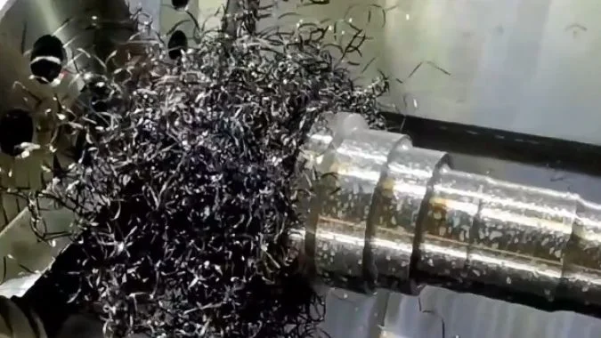 Turning chips accumulating around a CNC lathe chuck and jaws