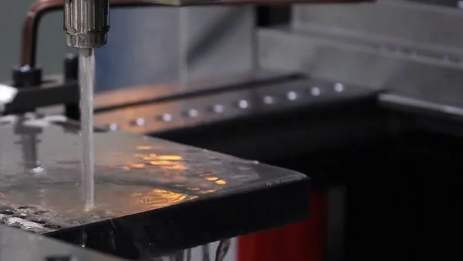 Medium-speed wire EDM machine processing a metal part